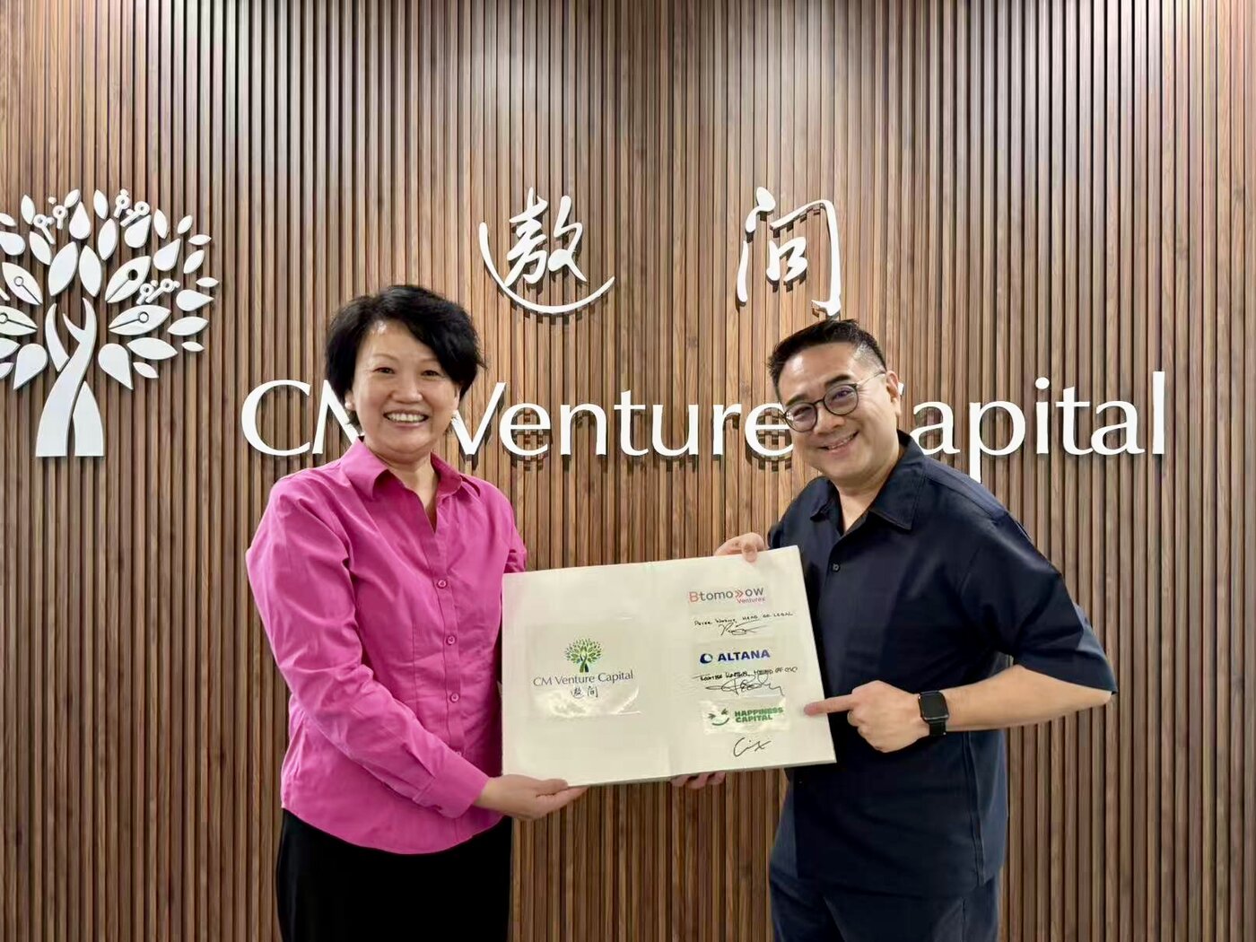Min Zhou and Eric Ng holding the Evergreen Fund LP book
